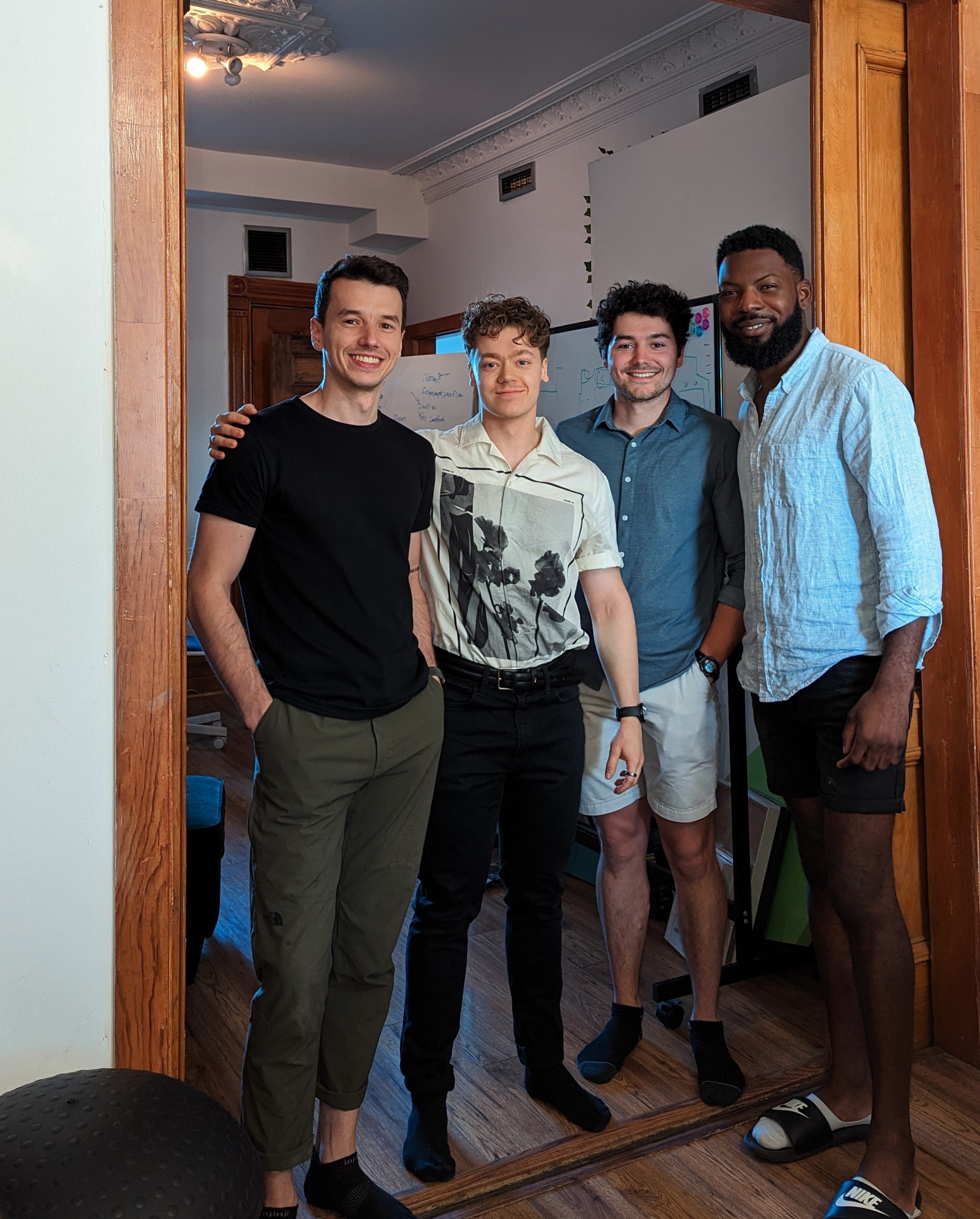 Four Growth Hub founders smiling together inside the co-living space